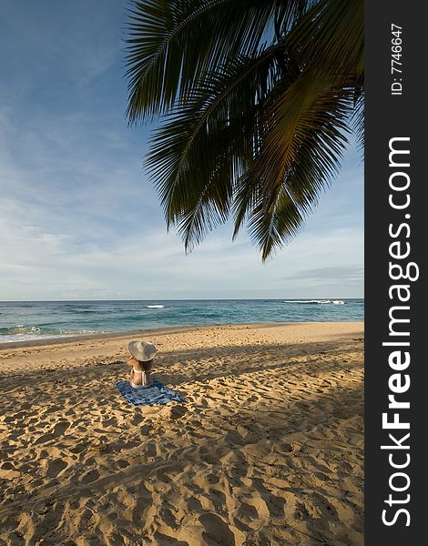 Girl sitting on the beach in Dominican republic
