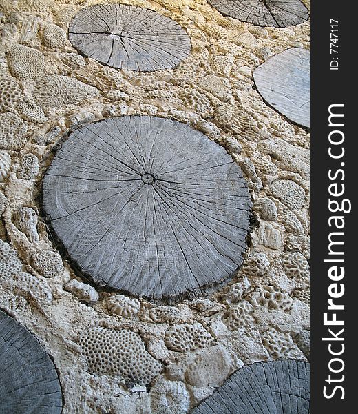 A beach resort path made of coral, sand and wooden stumps. A beach resort path made of coral, sand and wooden stumps