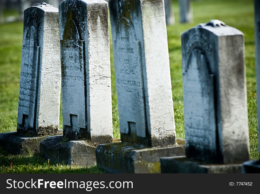 A group of old weathered carved gravestones