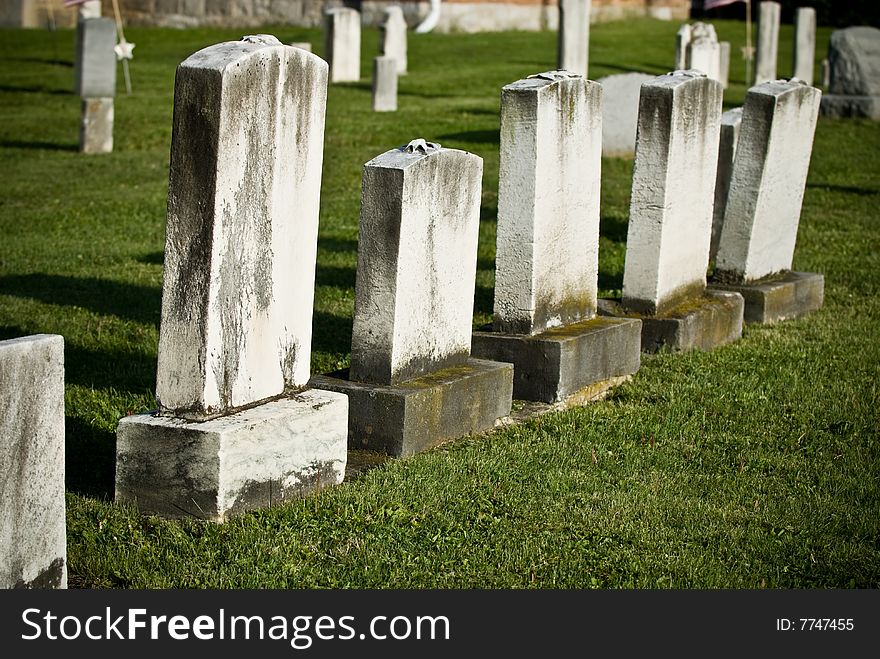 A group of old weathered blank gravestones