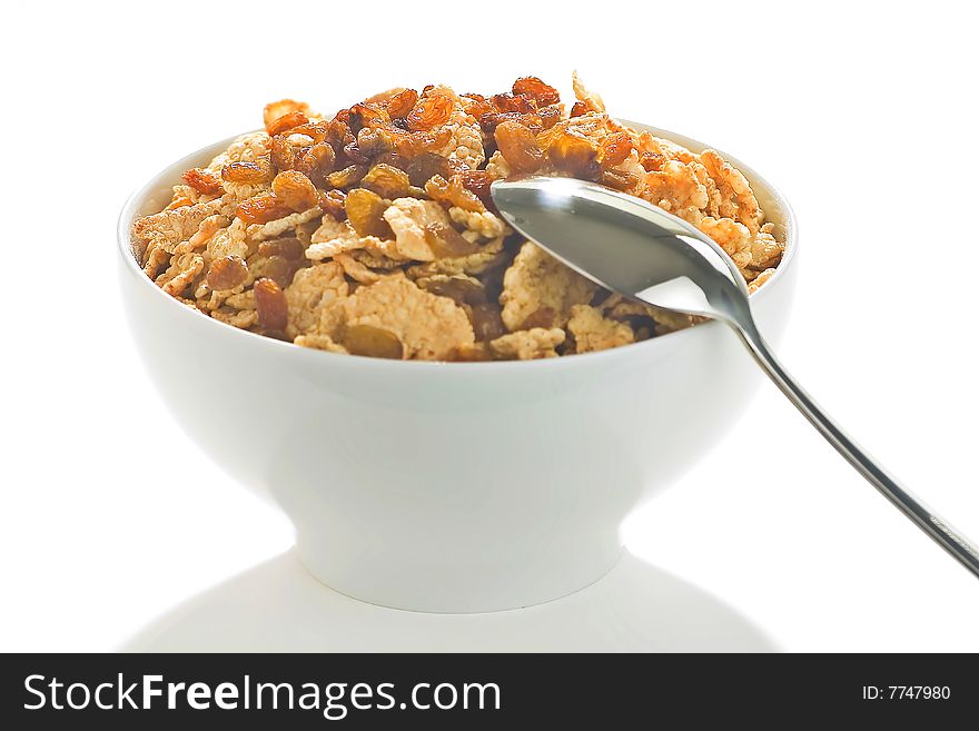 Bowl of cereal with raisins, milk and orange juice