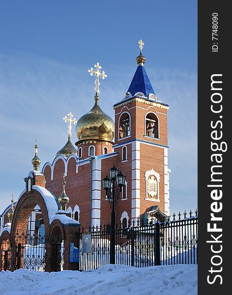 Church costing at top of a hill on a background of the dark blue sky