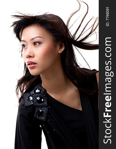 Young asian woman in black with wind blowing in her hair. Young asian woman in black with wind blowing in her hair