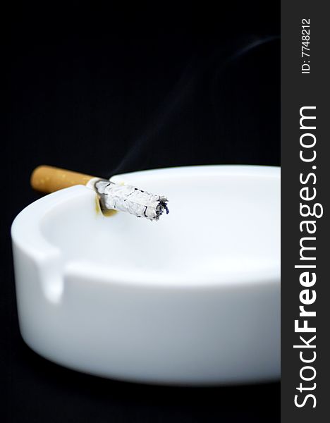 Cigarette butt in ashtray - No smoking