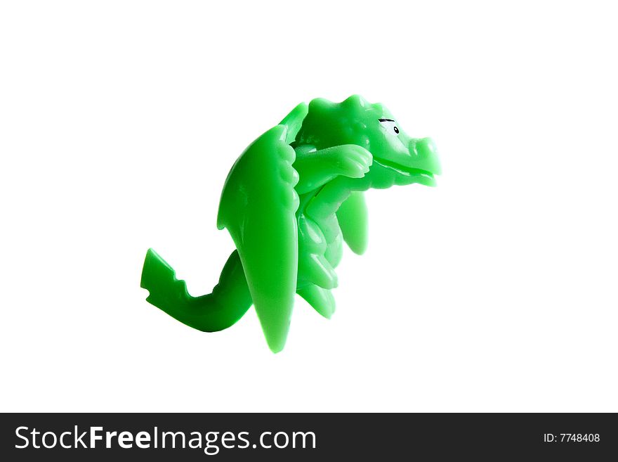 Green dragon toy close-up isolated on a white background