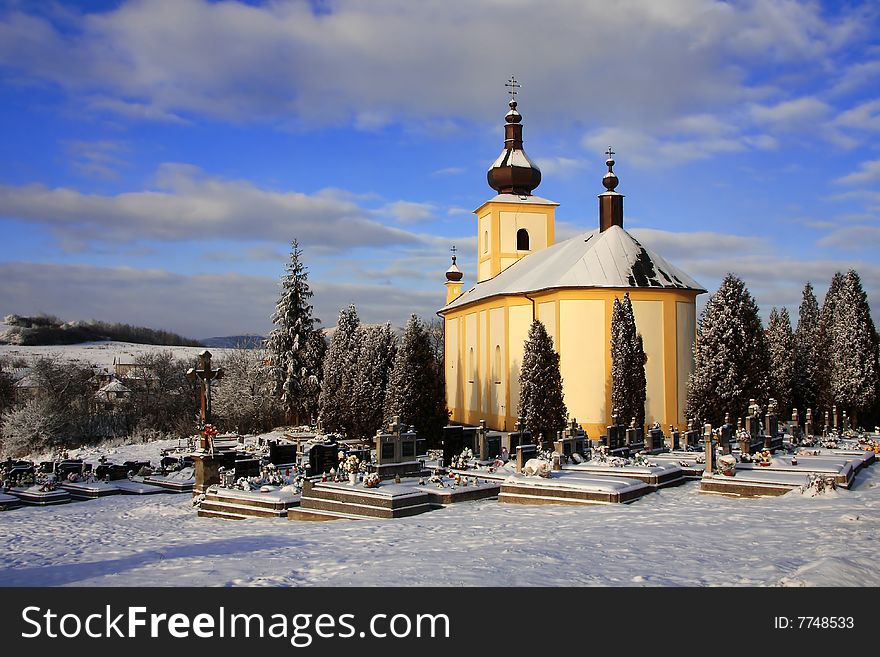 The old church with cemetery in the winter