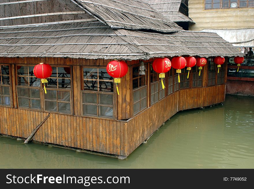 Typical Chinese decoration for New Year. Red lantern surrounding wooden houses in Guangdong province. Typical Chinese decoration for New Year. Red lantern surrounding wooden houses in Guangdong province.