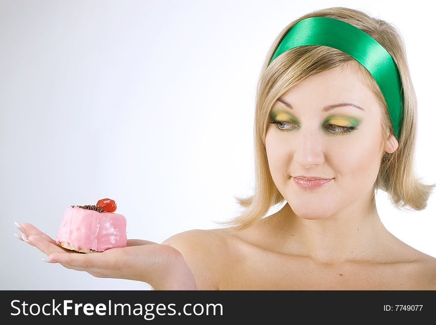 Beautiful girl looking on rose cake in hand. Beautiful girl looking on rose cake in hand