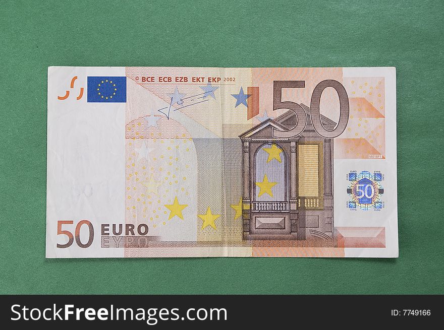 Fifty euro bank-note isolated over green background