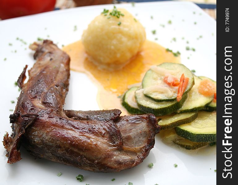 A fresh meal of rabbit meat with potatoes and zucchini