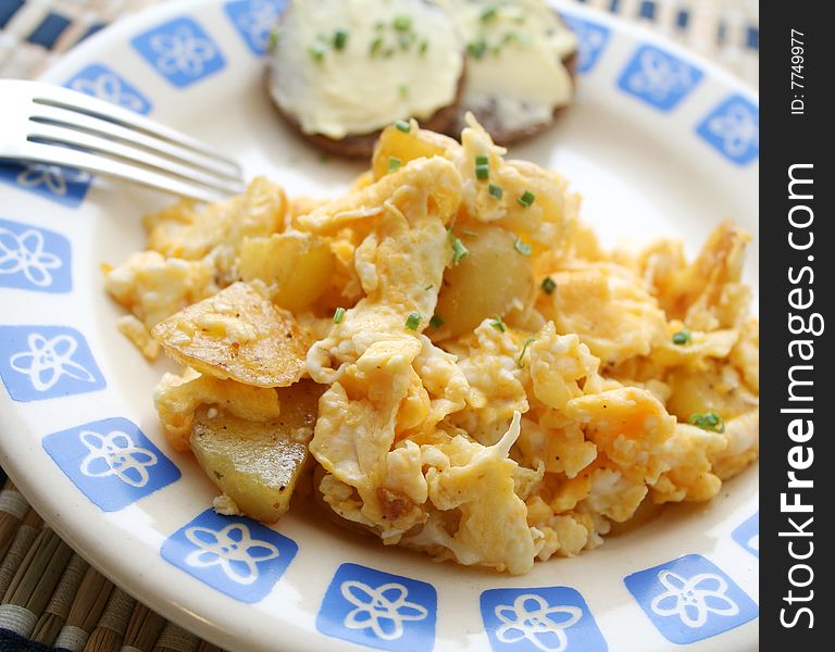 A meal of potatoes with eggs and bread