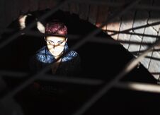 Punk Girl Sitting On The Floor Behind Metal Bars Stock Photography Punk Girl Sitting On The Floor Behind Metal Bars Stock Photography
