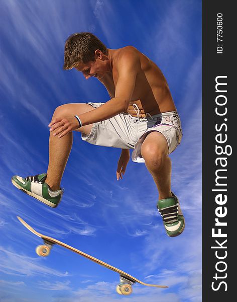 Boy with skateboard against a blue sky with clouds. Boy with skateboard against a blue sky with clouds