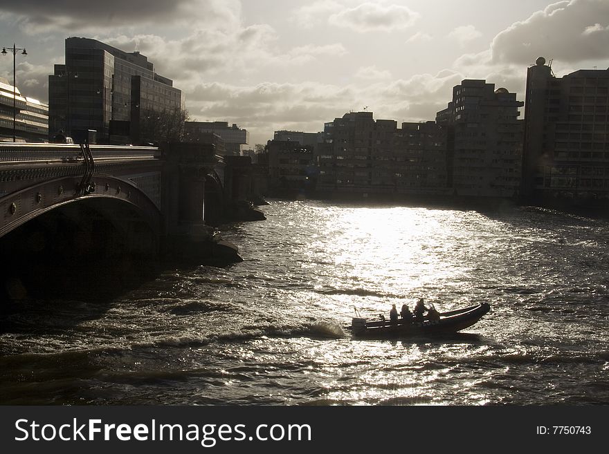 Silhouetted speedboat on the river in London. Silhouetted speedboat on the river in London