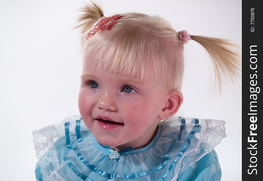 Child in blue gown smiles. Child in blue gown smiles