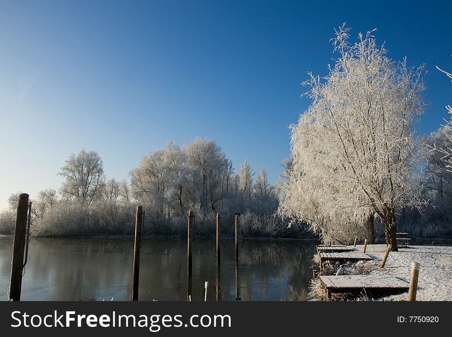 Winter scenery with some poles in a lake