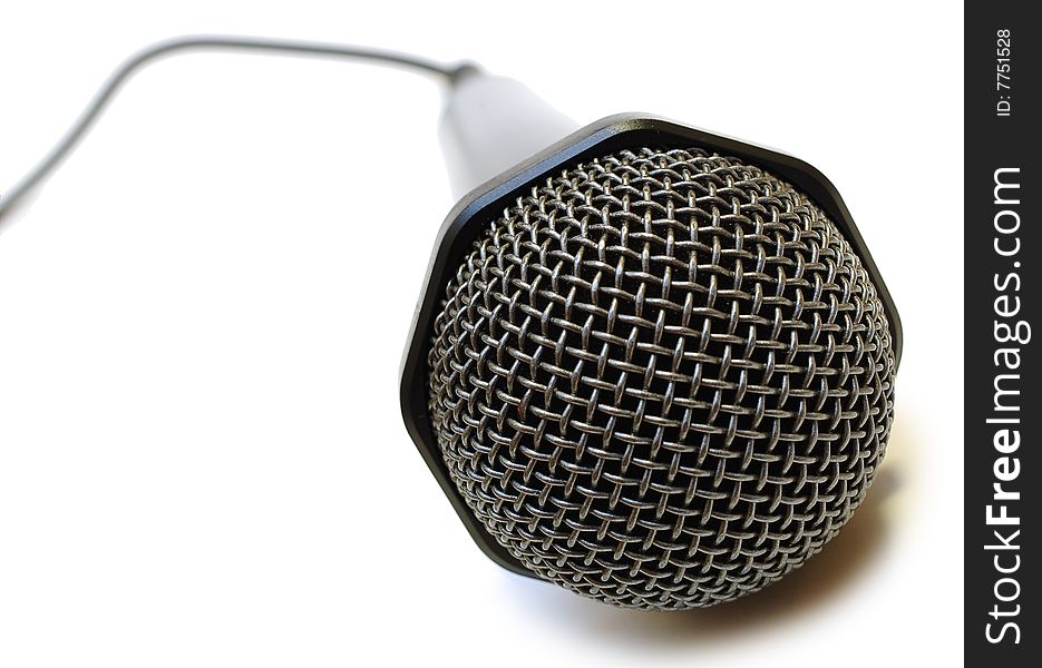 Black wired karaoke microphone with gray metal grill on isolated background. Black wired karaoke microphone with gray metal grill on isolated background.