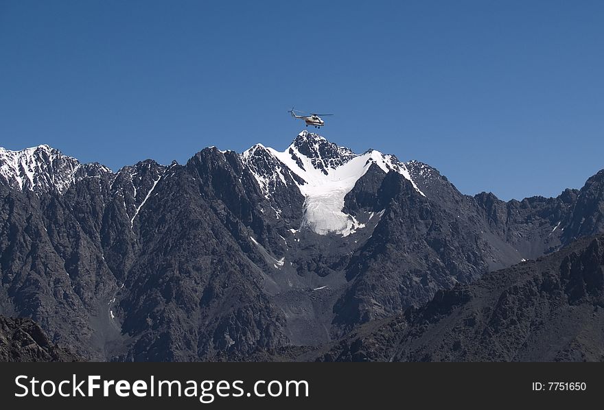 Helicopter in the mountains, sky