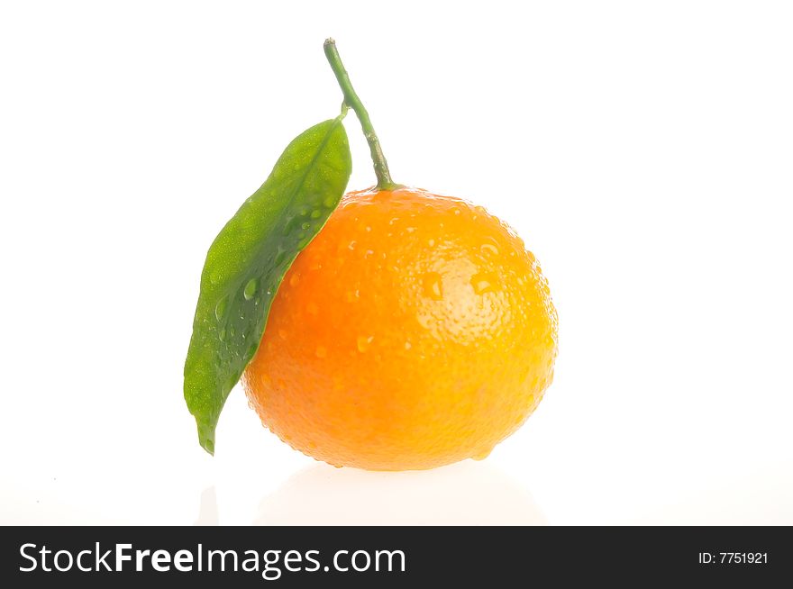 A small fresh juicy orange with leaf
