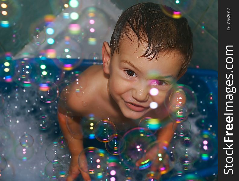 Close up of boy in soap bubbles