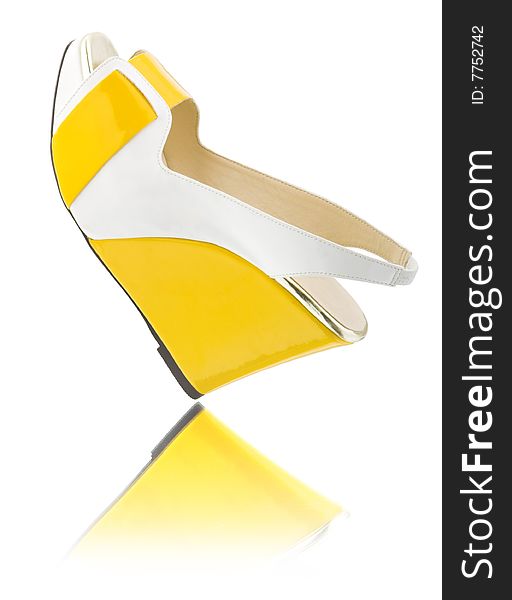 Yellow shoe on white with reflrction. Yellow shoe on white with reflrction