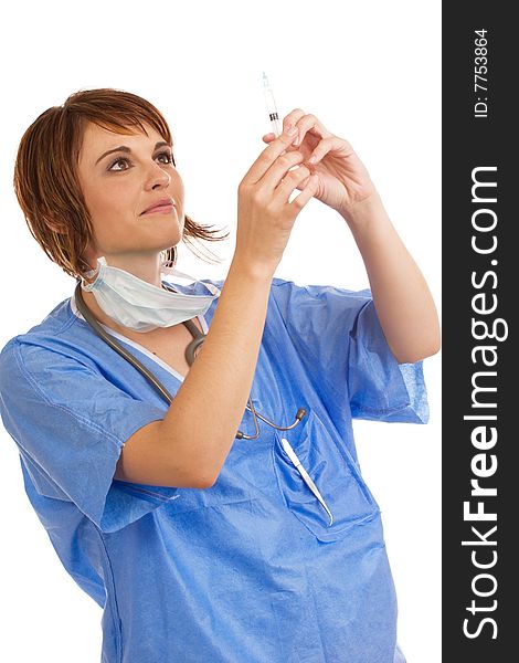 Attractive young female Caucasian doctor holding up and inspecting a filled syringe for air bubbles. Attractive young female Caucasian doctor holding up and inspecting a filled syringe for air bubbles