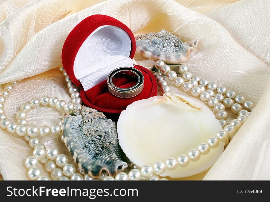 Wedding rings and shell and pearl