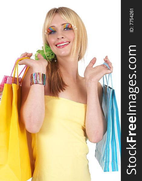 Portrait of a beautiful blonde woman with light blue eyes and colorful make-up holding shopping bags isolated on white background. Portrait of a beautiful blonde woman with light blue eyes and colorful make-up holding shopping bags isolated on white background