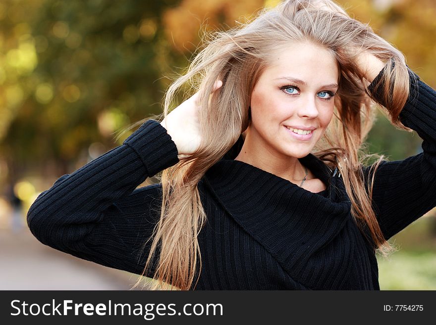 Beautiful Woman In Autumnal Park