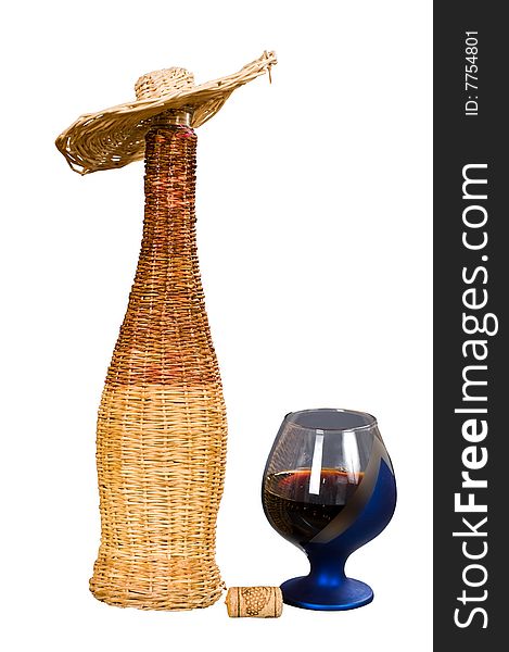 Red wine in a glass and a bottle braided by willow rods. Red wine in a glass and a bottle braided by willow rods.