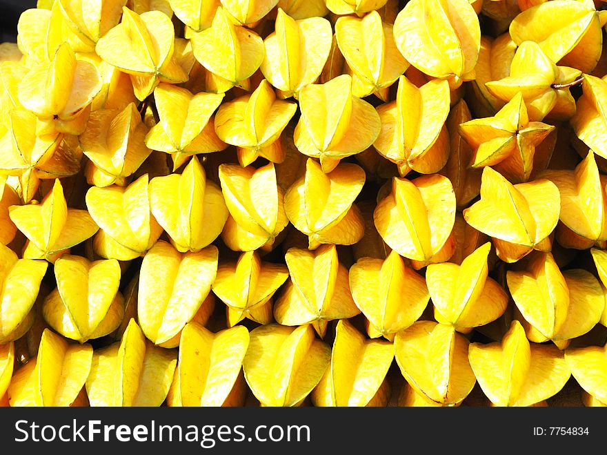 The golden juicy carambola fruit pile up in stack. The golden juicy carambola fruit pile up in stack.