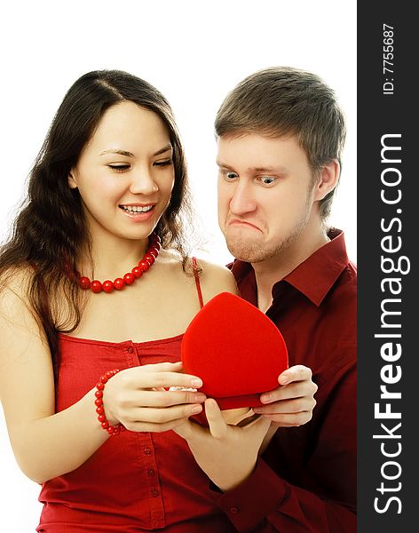 Surprised young couple opening a present isolated against white background