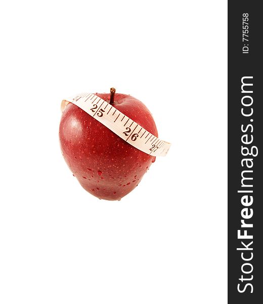 Red apple and measurement tape on white