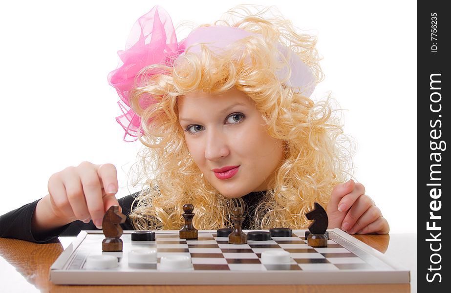 A glamor blonde plays a chess