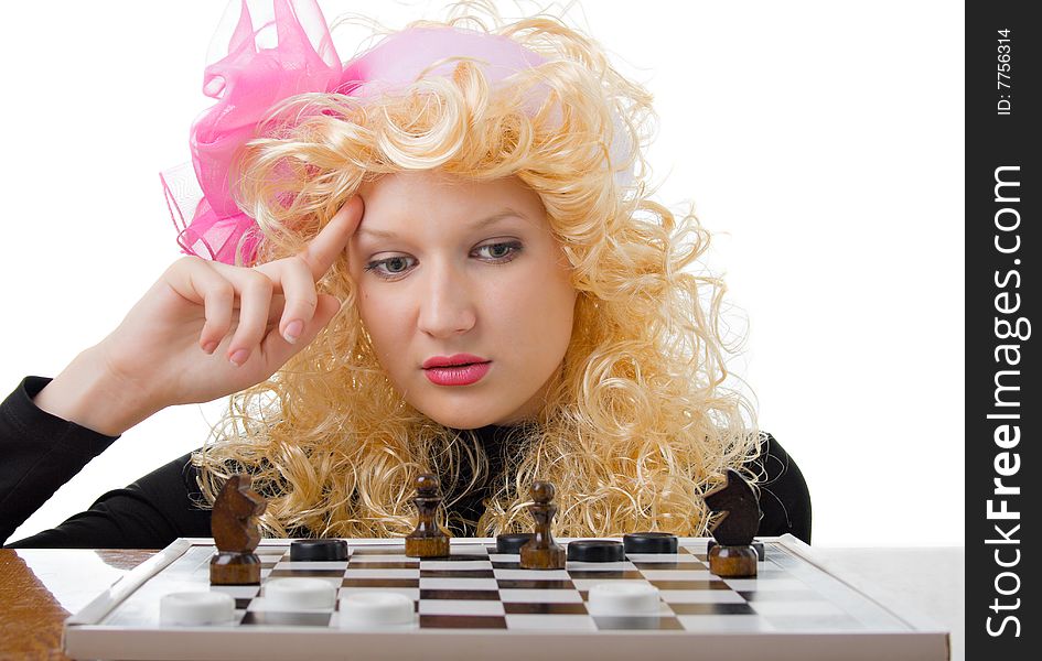 A glamor blonde plays a chess