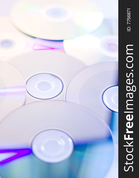 An arrangment of compact discs reflecting spectrum colors