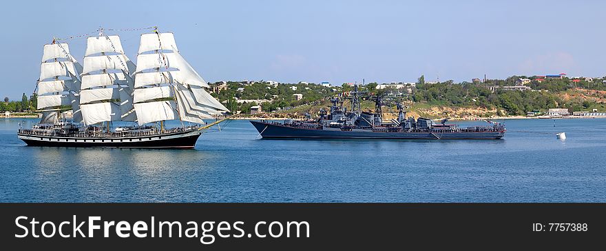 Sailfish and warship in harbour. Sailfish and warship in harbour