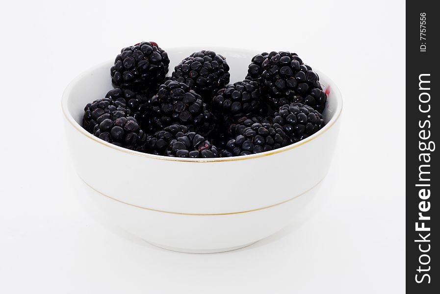 A bowl of fresh blackberries, isolated on white. A bowl of fresh blackberries, isolated on white