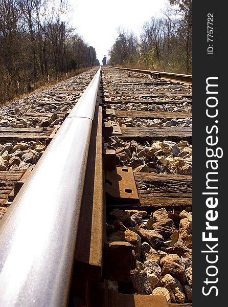 Looking down the rail of a railroad track.  Cross ties and gravel are visible. Looking down the rail of a railroad track.  Cross ties and gravel are visible.