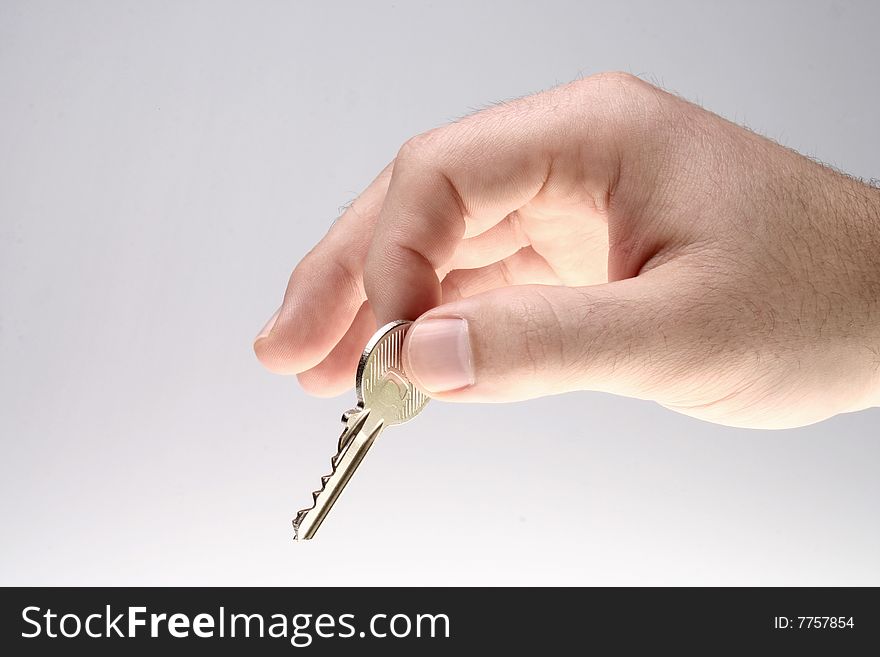 Man handing over a house key. Man handing over a house key