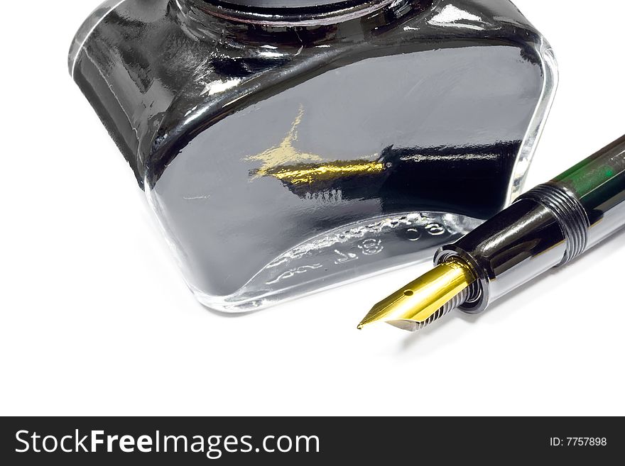 A jar of black writing ink and fountain pen. A jar of black writing ink and fountain pen