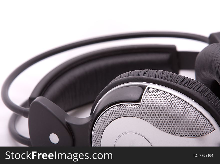 Blackly grey headphones on a grey background. Blackly grey headphones on a grey background