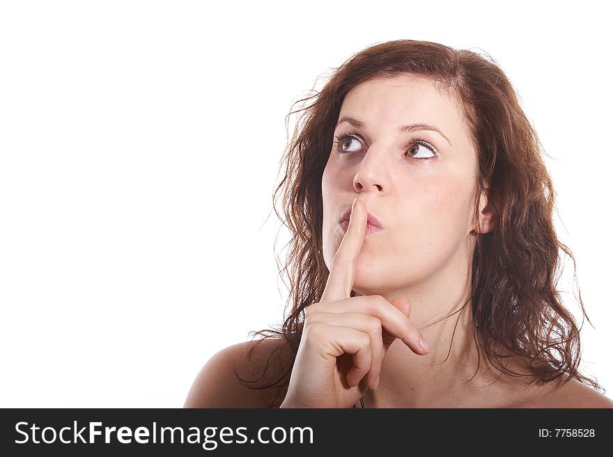 A young beautiful woman with a finger over her lips. Isolated over white with a lot of copy space. A young beautiful woman with a finger over her lips. Isolated over white with a lot of copy space.