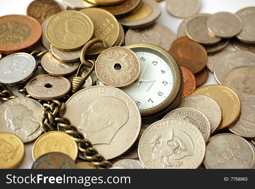 Pocket watch among coins. Time is money concept.