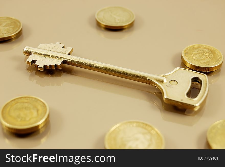 Golden key with coins symbolizing secure investment. Golden key with coins symbolizing secure investment
