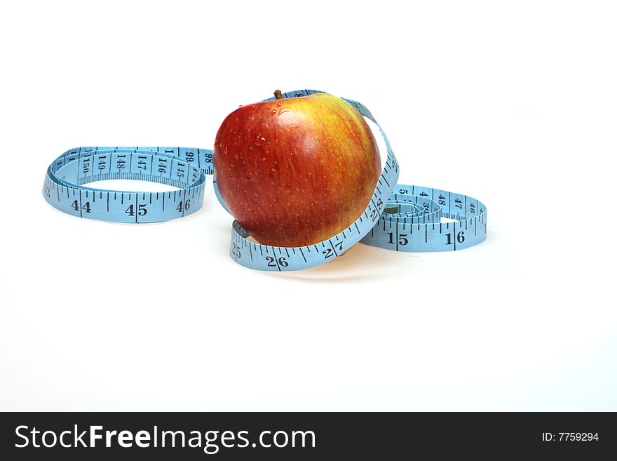 A red apple with blue tape measure healthy eating and life style  dietconcept. A red apple with blue tape measure healthy eating and life style  dietconcept