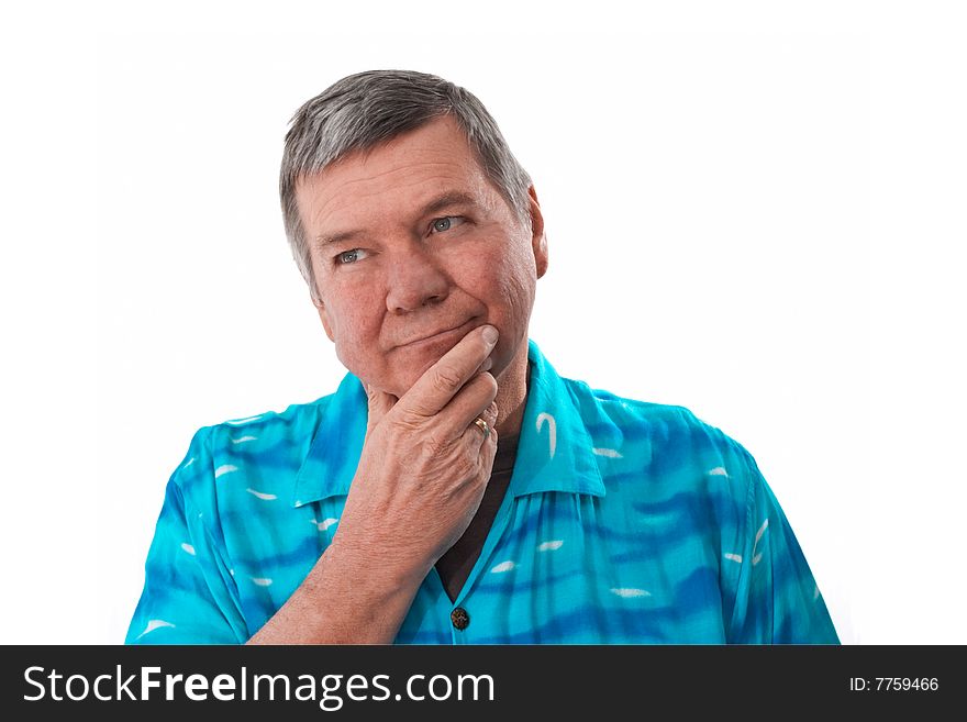 Portrait of a reflective 57 year old senior man wearing a bright blue shirt, isolated on white background. Portrait of a reflective 57 year old senior man wearing a bright blue shirt, isolated on white background.