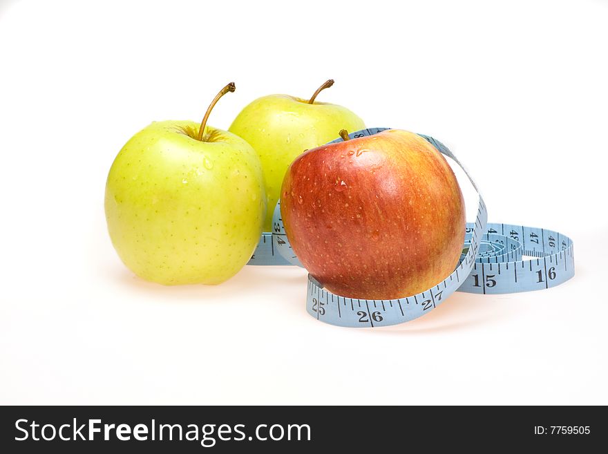 A red apple and green apples with blue tape measure healthy eating and life style  dietconcept. A red apple and green apples with blue tape measure healthy eating and life style  dietconcept