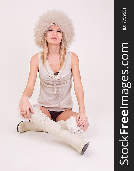 Pretty young girl in furry hat, studio shot