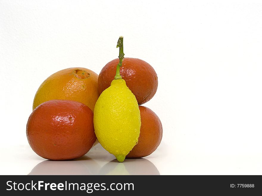 One Orange, one Lemon and three Clementines isoleted over a white backgroud. One Orange, one Lemon and three Clementines isoleted over a white backgroud